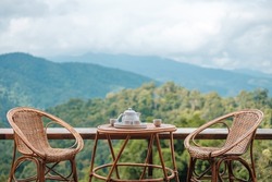 teapot set on table in the morning with mountain view at countryside home or homestay. Vacation, travel and trip concept