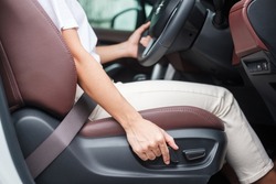 Hand adjust car seat before drive on the road . Ergonomic and safety transportation concept