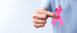 Pink October Breast Cancer Awareness month, man hold pink Ribbon for support people life and illness. National cancer survivors month, Mother and World cancer day concept
