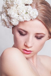 BEAUTY portrait of a girl with flowers in her hair. Girl with the white  lilac flowers. Fresh Clean Skin. 