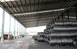 Stacked of high carbon wire rod in storage house, Metal steel wire roll for heavy industry production, concrete usage and building construction