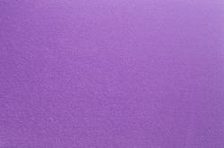 Felt surface in deep dark purple color. Abstract background and texture for design.