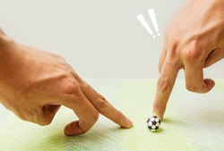Playing socker made by paper with  fingers,The human use fingers slice paper football,Dangerous while playing football