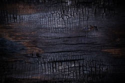 Burnt wooden Board texture. Halloween backdrop. Burned scratched hardwood surface. Smoking wood black plank halloween background