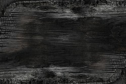 Burned noisy scratched hardwood surface. BBQ background. Burnt wooden Board texture.  Smoking wood plank background. Burned wooden grunge texture. 