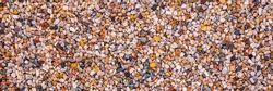 Premium Quality colourful quartz aquarium substrate. Multicolour decorative gravel background. Garden pond gravel backdrop. Terrarium natural Sand texture. Cacti Succulents sandy Soil Mix. Banner.