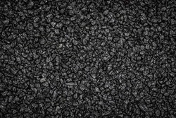 Noisy Black basalt gravel background. Dark sand texture. Lots of small stones. Dark quartz aquarium substrate. Garden pond gravel backdrop. Terrarium natural fine-grained igneous lava rock