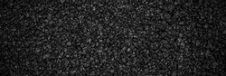 Noisy Black basalt background. Banner. black sand texture. Lots of lava small stones. Dark quartz aquarium substrate. Garden pond gravel backdrop. Terrarium natural  fine-grained igneous rock