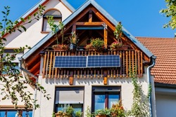 Solar battery on balcony wall of vintage house in Germany. Balcony power plant. Mini PV plants generate your own electricity plug  play. Mini photovoltaic plant. Small Solar Panel energy system. 