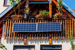 Solar battery on balcony wall of vintage house in Germany. Balcony Mini photovoltaic power plant. Mini PV plants generate your own electricity plug  play.  Small Solar Panel energy system. 