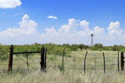 barbed wire fence and windmill in west Texas