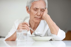Sick asian senior woman suffering from anorexia,bored with meal,eating less food,discomfort in swallowing,disease of Dysphagia,Old elderly patient with Anorexia-Cachexia syndrome,lack of appetite