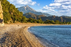 Picturesque beach in Cirali (Olympos beach). Sea and mountains. Kemer, Antalya, Turkey.