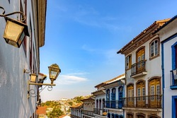 Historic city of Ouro Preto in Minas Gerais with its colonial architecture houses, lanterns and a church in the background
