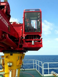 Crane operation, Crane boom, Crane cabin room at offshore wellhead platform.