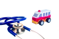 Toy wood ambulance car and stethoscope on white background. close up.