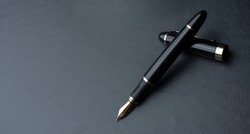 
Beautiful fountain pen. under exposed photo on a black background.