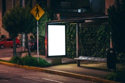 White isolated backlit ad space at a bus stop on the street