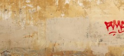 Distressed Yellow Brown Old Brick Wall With Graffiti Street Art. Background And Painted Lines And Draw. Abstract Grunge Modern Grafitty Wallpaper. Abstract Plastered Wall Web Banner. Design Element.