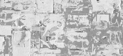 Grunge Wide Background with Old Torn Posters. Urban Graffiti Wall Texture. Grungy Ripped Wall with Torn Posters and Ads Background. Panoramic Urban Wallpaper. Graffiti Wall Texture.