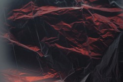 abstract black-and-red texture made of crumpled polyethylene