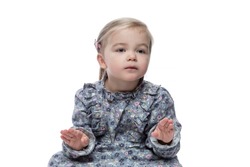 Cute little girl in a dress with a soothing face and a soothing and a soothing gesture with her face. Funny child, picture for memes. Isolated on a white background.