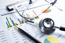 Stethoscope, Charts and Graphs paper, Saving stack coins money, globe and credit card. Finance, Account, Statistics, Investment, Analytic research data economy and Business company meeting concept.