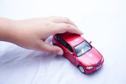Children kid playing red color car toy on white background