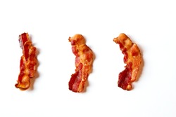 Three slices of fresh fried bacon lined up in a row isolated on a white background