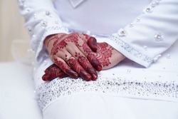 Elegant Wedding Ring with Beautiful Henna on the Malay Bride's Hand.