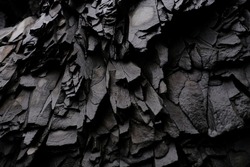 Textures and patterns of basalt volcanic rock formations at Hálsanefshellir Cave next to the Reynisfjara black sand beach, Iceland
