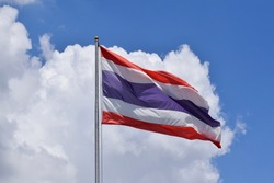 Thailand flag isolated on the blue sky. close up waving flag of Thailand. flag symbols of Thailand,Image of waving Thai flag of Thailand with blue sky background.selective focus.