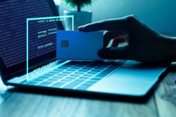 The concept of credit card theft. Hackers with credit cards on laptops use these data for unauthorized shopping. Unauthorized payments from credit card owners. In the hacker's secret office