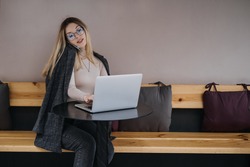Earn extra money, Side hustle, money making, turning hobbies into cash, Gig economy, digital nomad. Young woman, student with laptop and smartphone working outside. Selective focus
