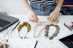 Jewelry Design: Learn the art of designing jewelry, including sketching, selecting materials, and creating prototypes. Female designer makes and design jewelry in workshop