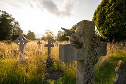 Church graveyard with gothic graves during golden hour in Derby, UK