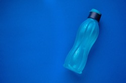 Eco bottle classic blue color of the year 2020 Pantone. Attribute of a healthy lifestyle. Flat view with copy space. Tool for fitness. Minimalism.