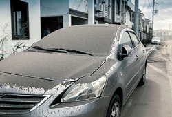 cars parked on the side of the dormitory affected from Volcanic dust fall, dirty surface car in the morning, ashes falling , concept dirty car, Blur background