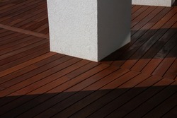 Hardwood Ipe decking, a freshly painted and stained wood deck on the exterior patio of the modern house design