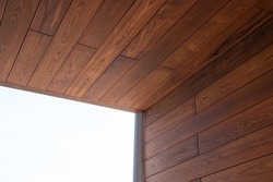Looking up at a modern luxury house detail of thermo wood cladding
