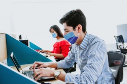 Latin People working in business office wearing medical face mask for social distancing in new normal situation protecting and preventing the infection of corona virus or covid-19 in Latin America 