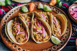 mexican tacos flat lay composition with pork carnitas, cochinita pibil, onion and habanero chili traditional food in Mexico