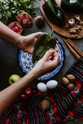 mexican woman cooking chiles en nogada recipe with Poblano chili and ingredients, traditional dish in Mexico