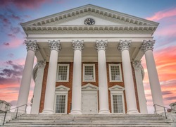 The famous rotunda building of the University of Virginia in Charlottesville with classic Greek arches design by President Jefferson iconic building of the campus with dramatic sunset sky