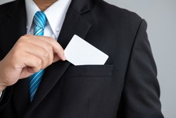 the Man showing a business cards in suit