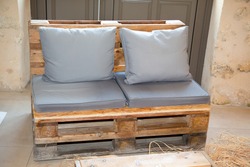 recycled wooden garden lounge and cushion on home terrace make in diy wood pallets