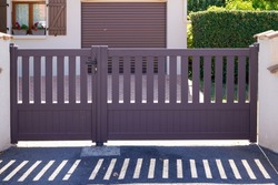 grey brown house steel access door aluminum gate at modern home entrance