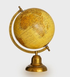 Classic old antique vintage Table world metal Globe model in yellow and gold color showing Africa map isolated on white background.