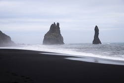 Stormy, moody day on black sand beach Reynisfjara on the south of Iceland, Europe, huge waves on Atlantic Ocean