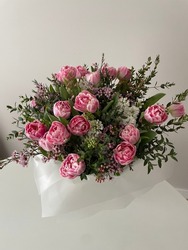 Bunch of spring flowers - pink tulips and white hyacinths with fresh greenery on the white table, hello spring, romantic gift